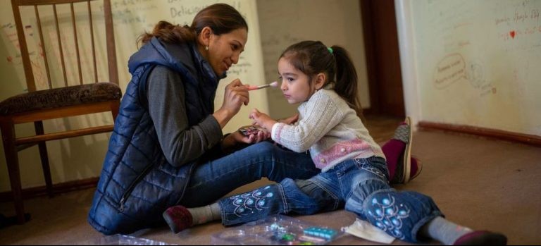 A mother plays with her daughter at home in Armenia