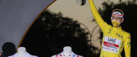 Tour de France winner Slovenia's Tadej Pogacar, wearing the overall leader's yellow jersey, celebrates on the podium after the twenty-first and last stage of the Tour de France cycling race over 122 kilometers (75.8 miles)