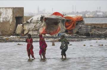 Pakistani flood victims cross sea water