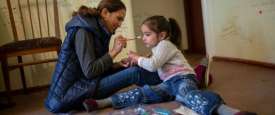 A mother plays with her daughter at home in Armenia