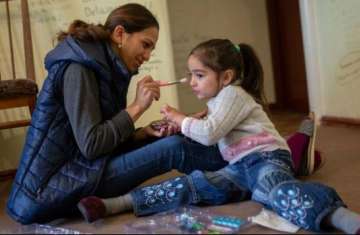 A mother plays with her daughter at home in Armenia